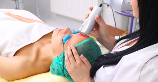 dermatologist performing a laser treatment for acne